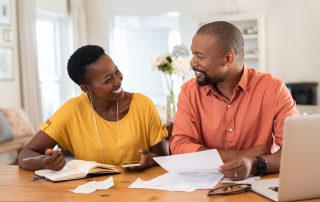 Happy Man and woman working on finances together